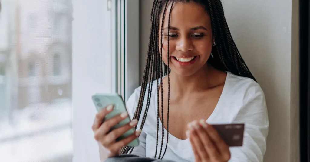 Woman in Canada checking her phone after a 50 dollar loan instant transfer