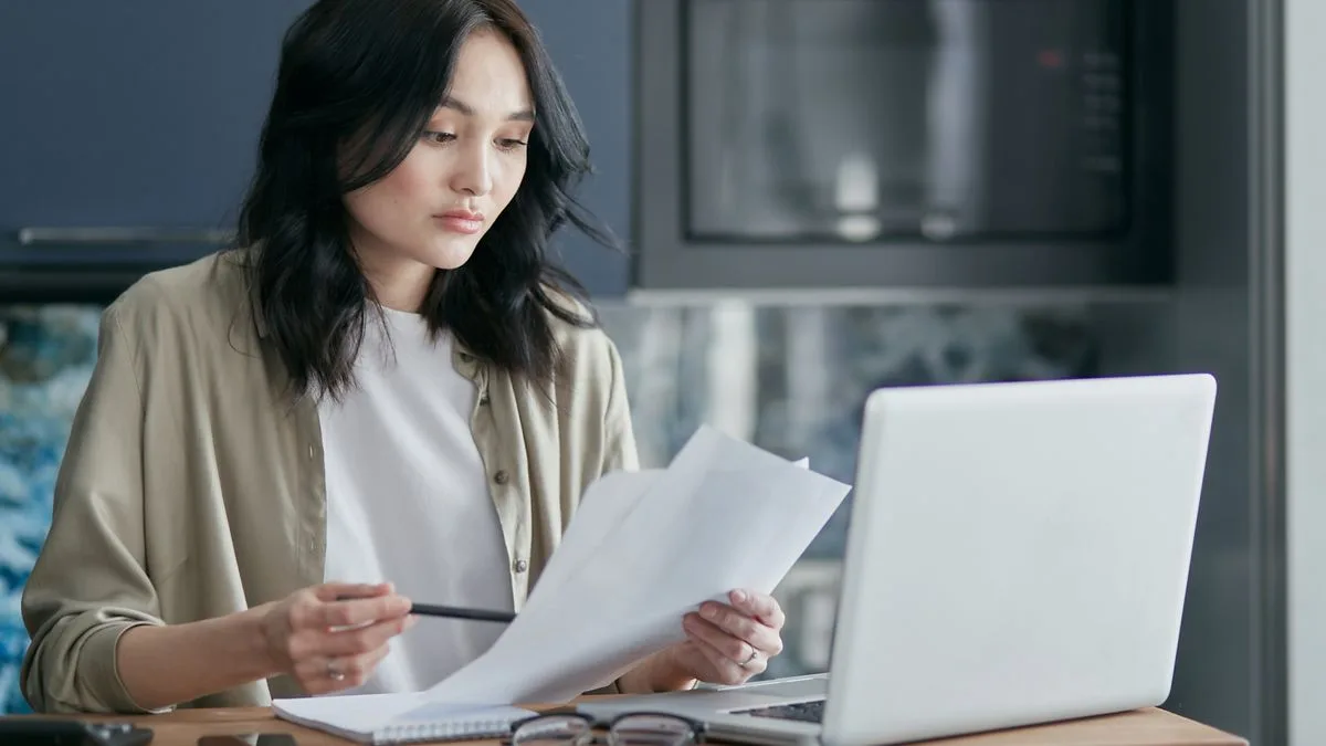 Woman applying for simple personal loans online with a laptop