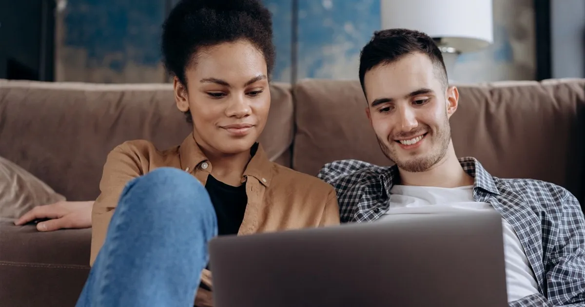 Couple comparing loan offers on a laptop in Canada