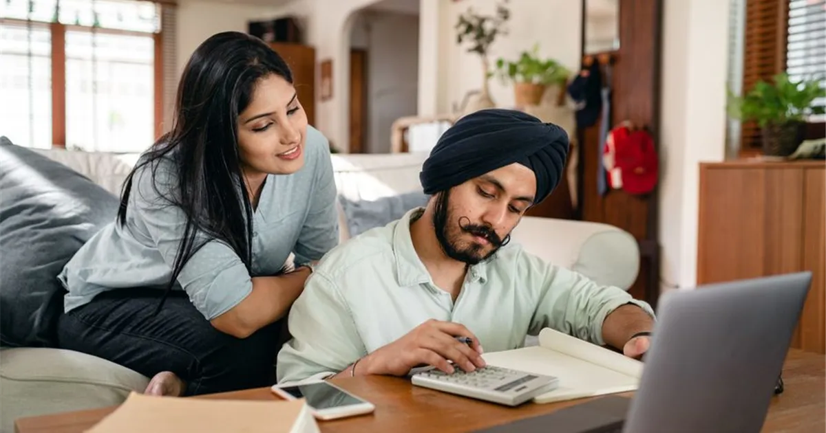 Canadian couple applying for a loan online at home
