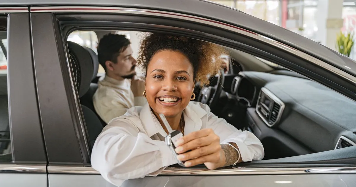 Couple financing a car after comparing auto insurance in Canada