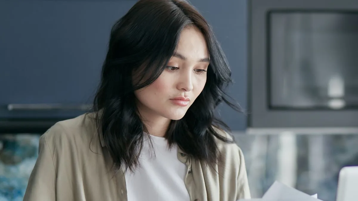 Woman comparing documents to choose the right loan option