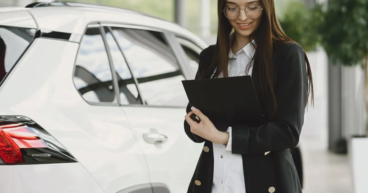 Person weighing co-signing a car loan at a Canadian dealership