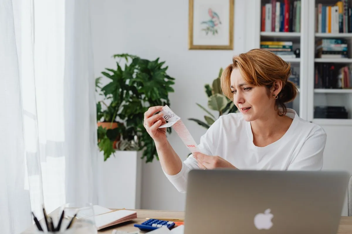 Person reviewing multiple bills before debt consolidation