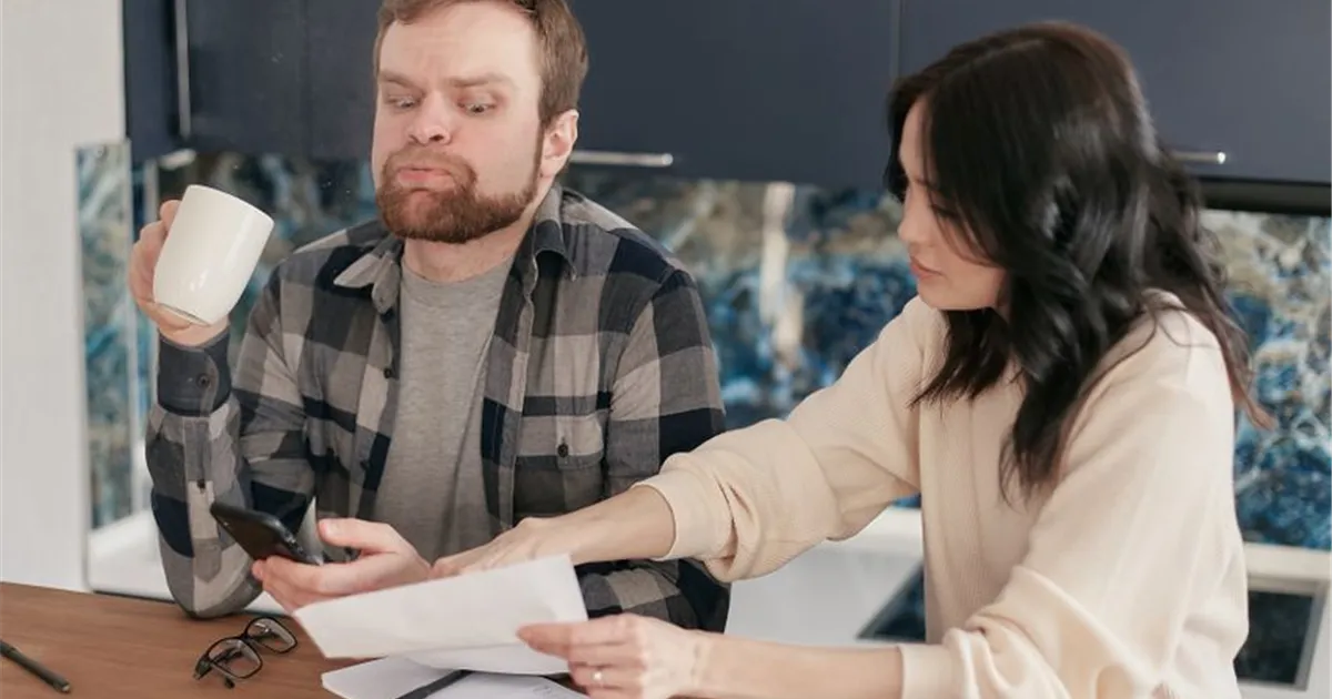 Canadian couple reviewing bills for debt consolidation