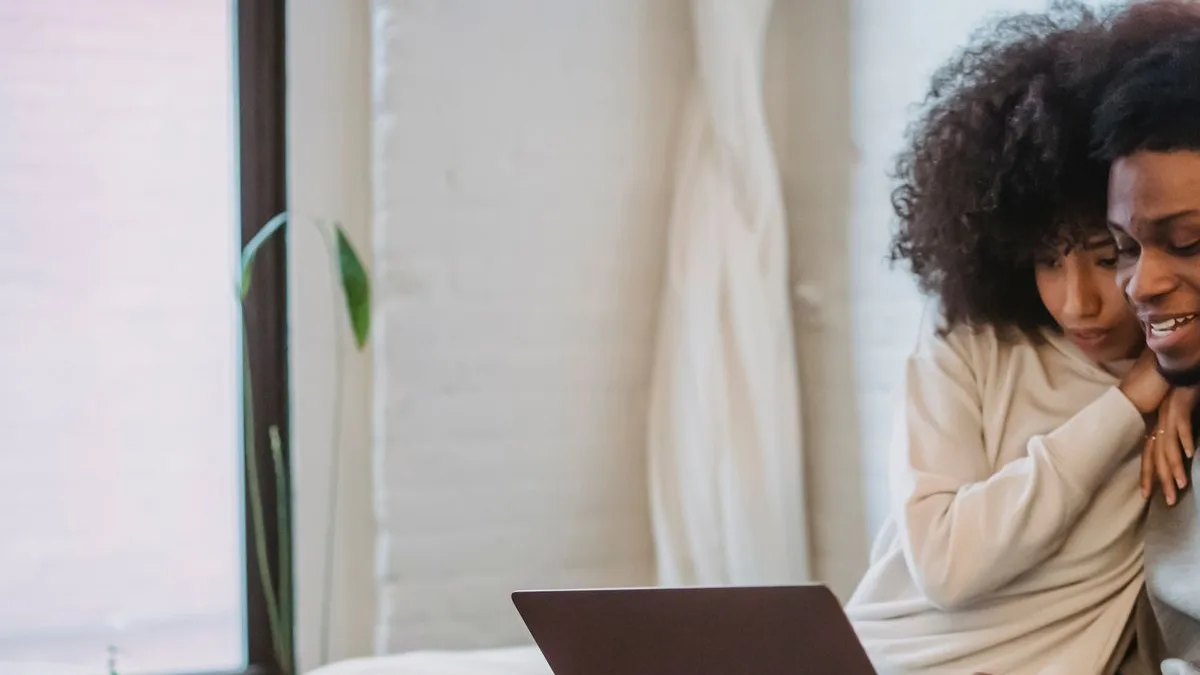 Couple checking how much they can save by consolidating debt with a personal loan