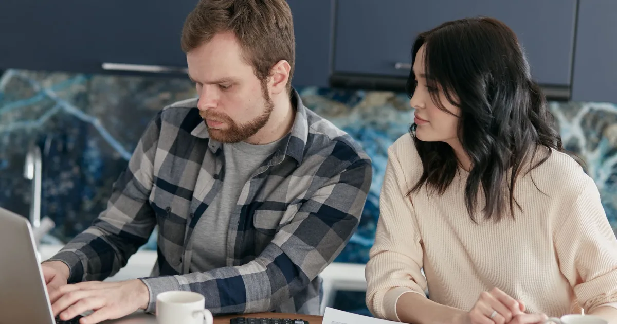 Canadian couple reviewing a guarantor loan application together at home