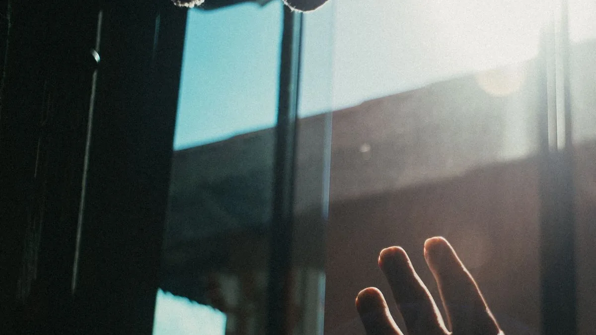 Reaching toward light symbolizing hope after debt forgiveness
