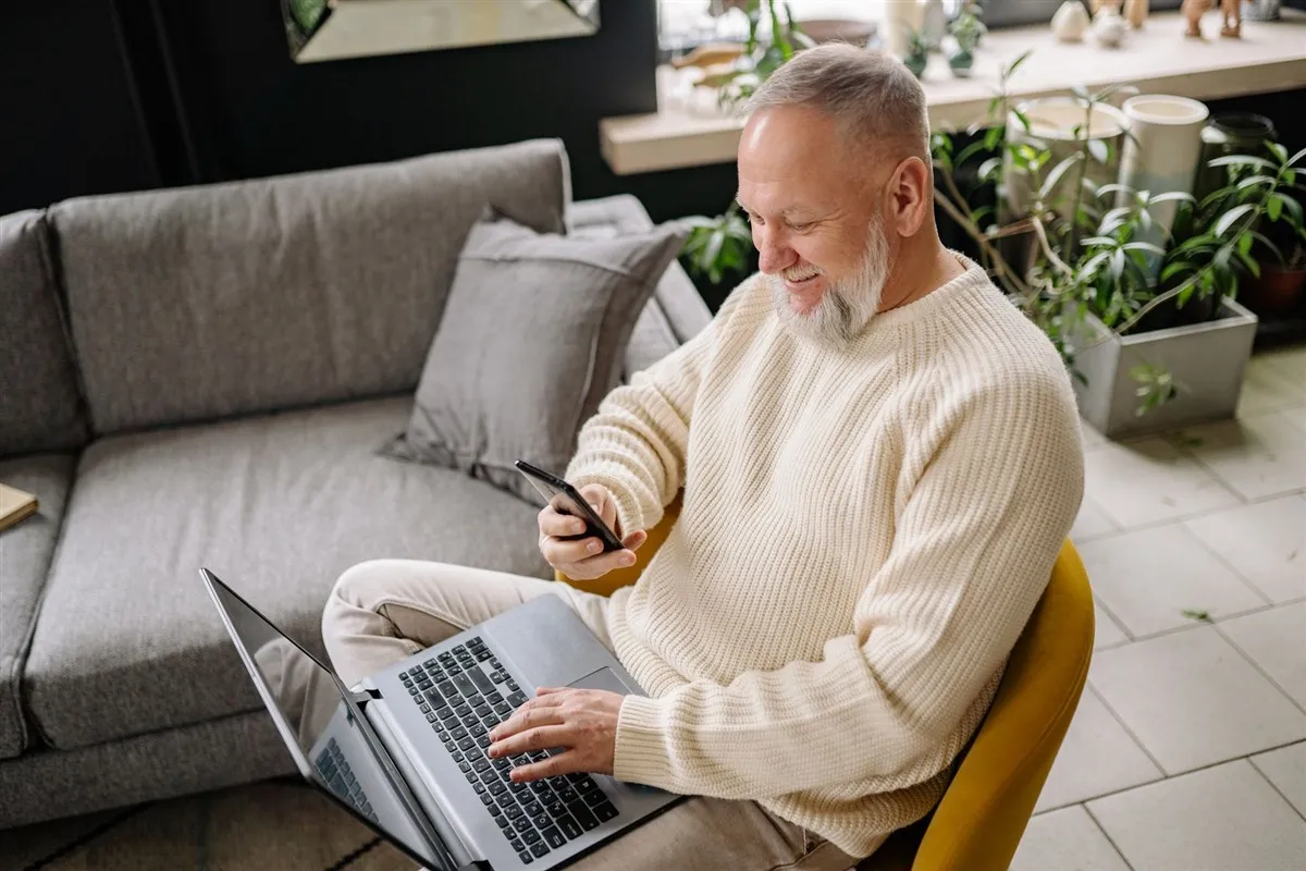 Man checking his instant e-transfer loans approval on his phone at home