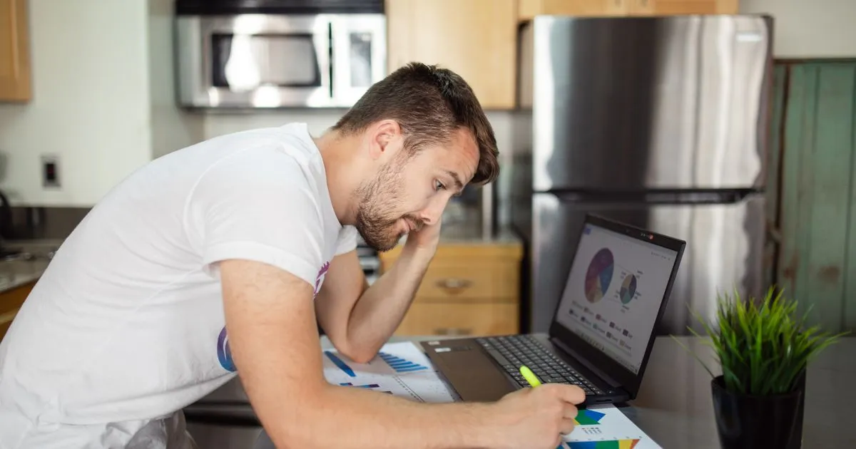 Reading Loanspot guides and money guides on a laptop