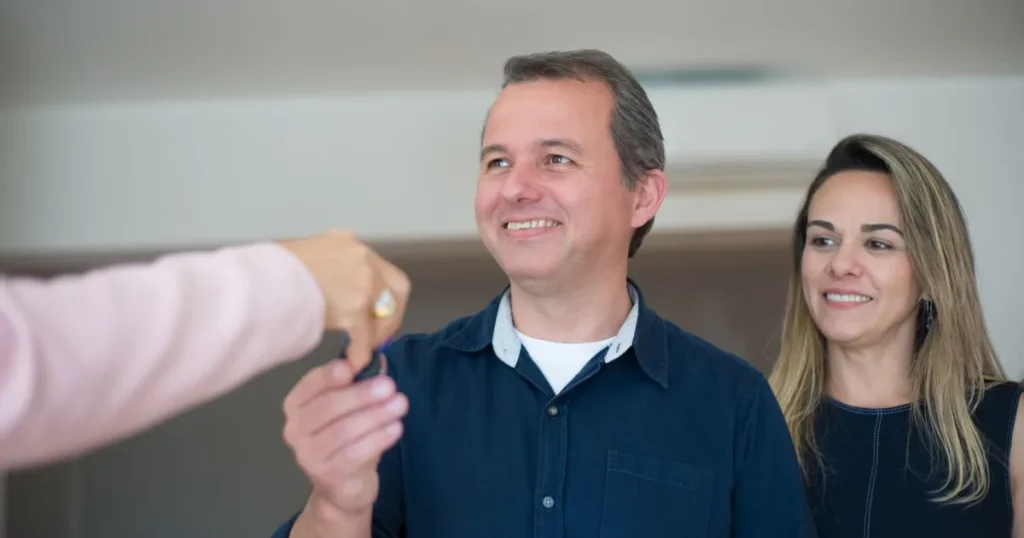 Canadian couple receiving keys after getting approved for a mortgage