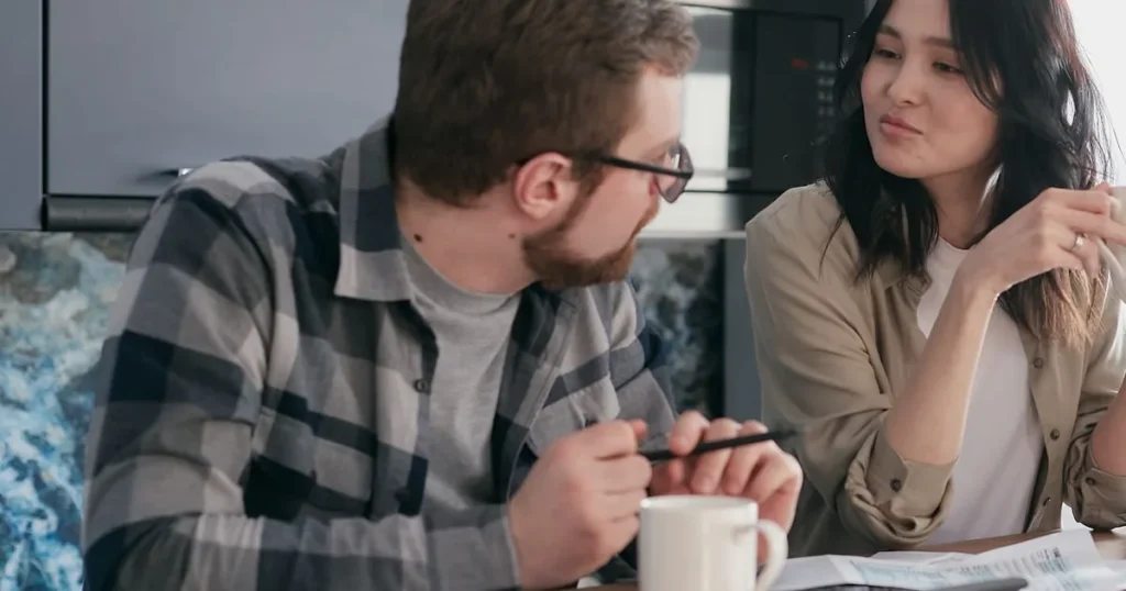 Couple reviewing bills considering a personal loan for debt consolidation in Canada