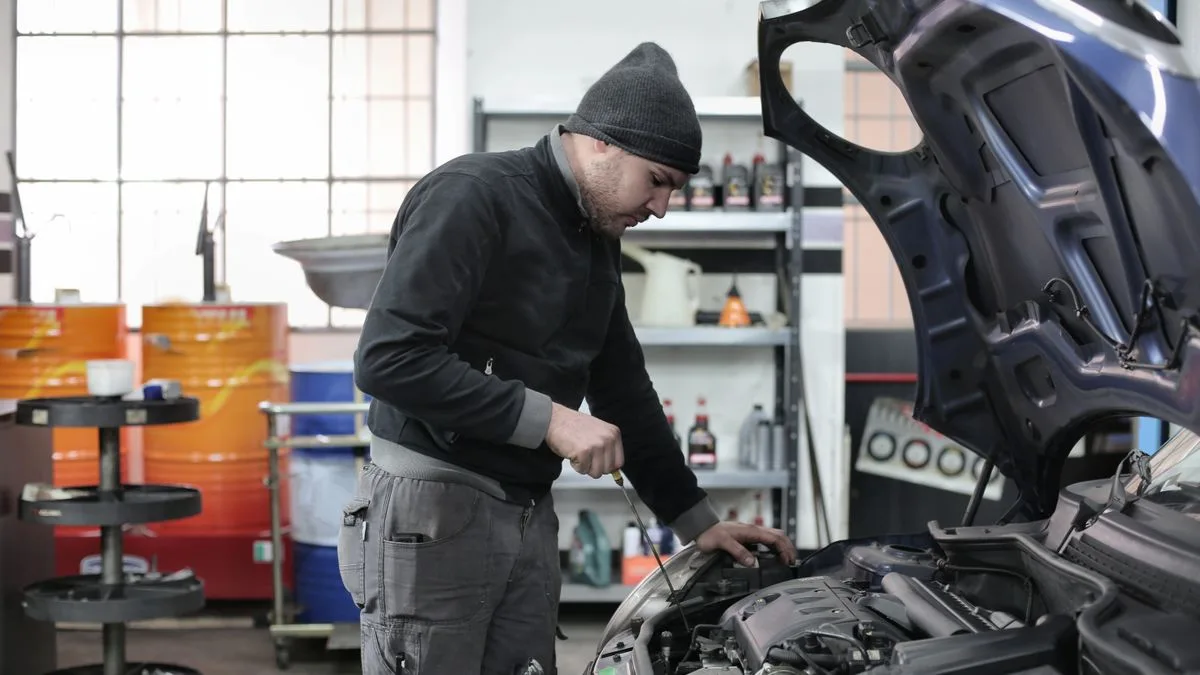Mechanic fixing a car engine, a common reason Canadians use same day loans