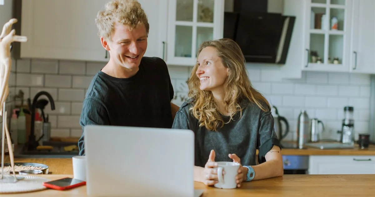 Couple comparing savings accounts at home in Canada