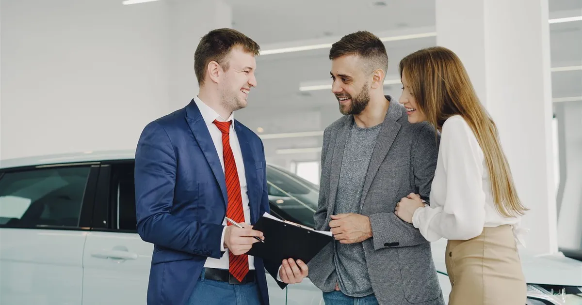 Couple getting a vehicle loan at a dealership in Canada