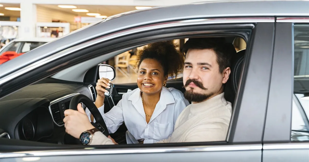 Happy owners in a new car bought with a vehicle loan in Canada