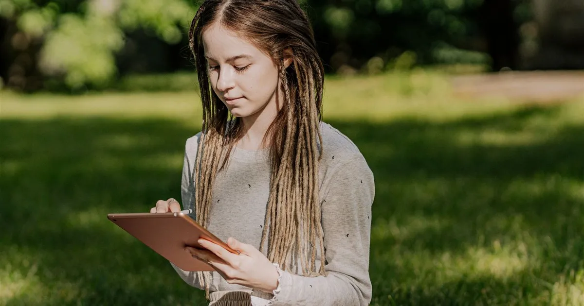 Young person using a banking app on a tablet in Canada