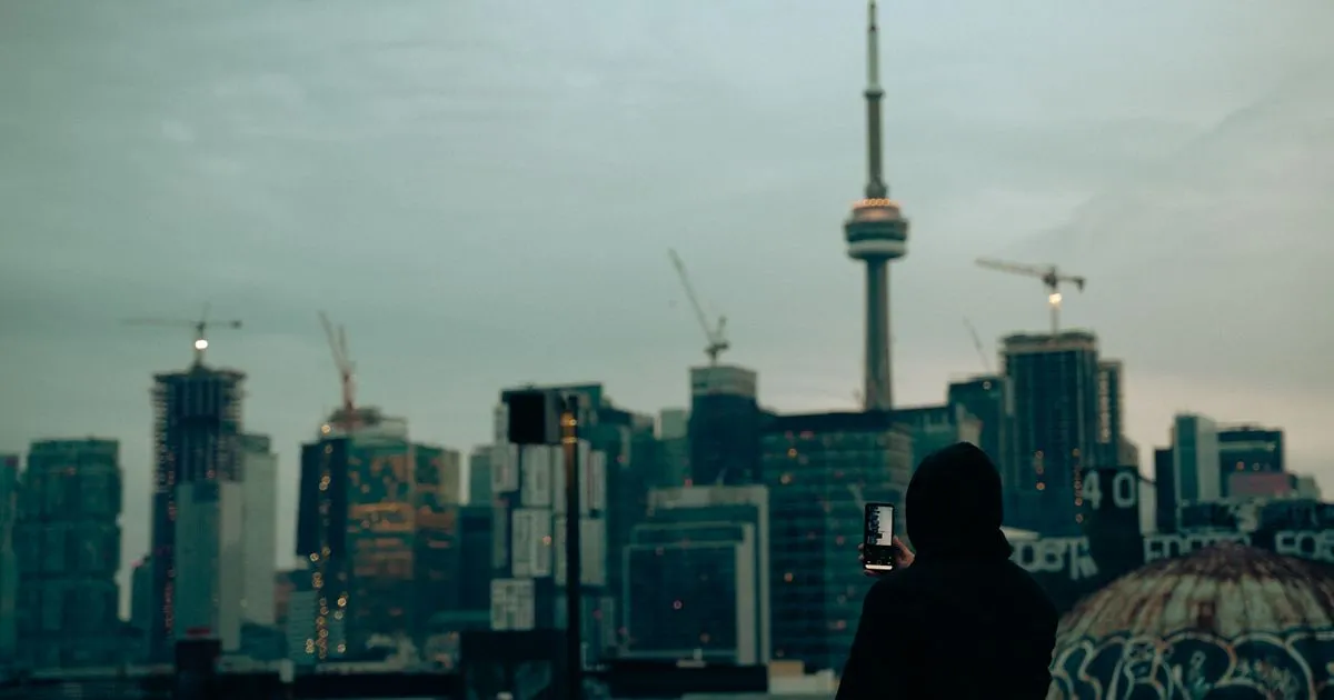$1000 loan no hard credit check options compared on a phone against the Toronto skyline