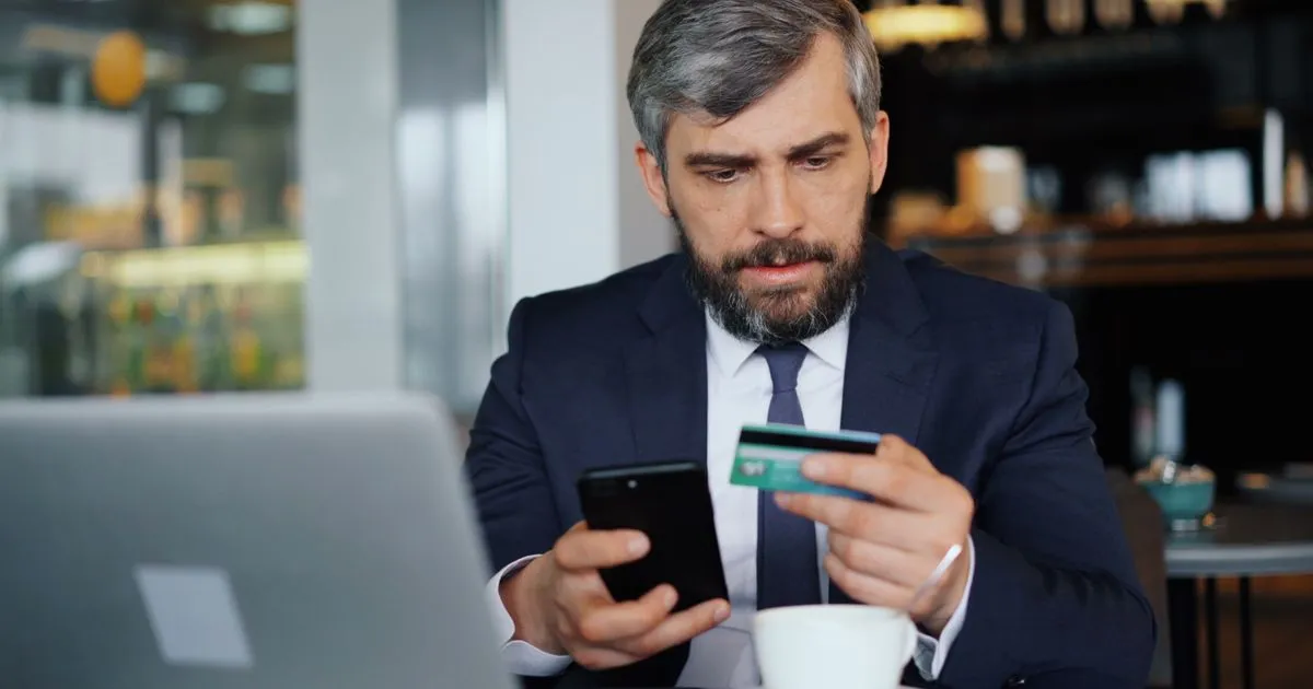 $300 loan no hard credit check application on a smartphone in a Canadian cafe
