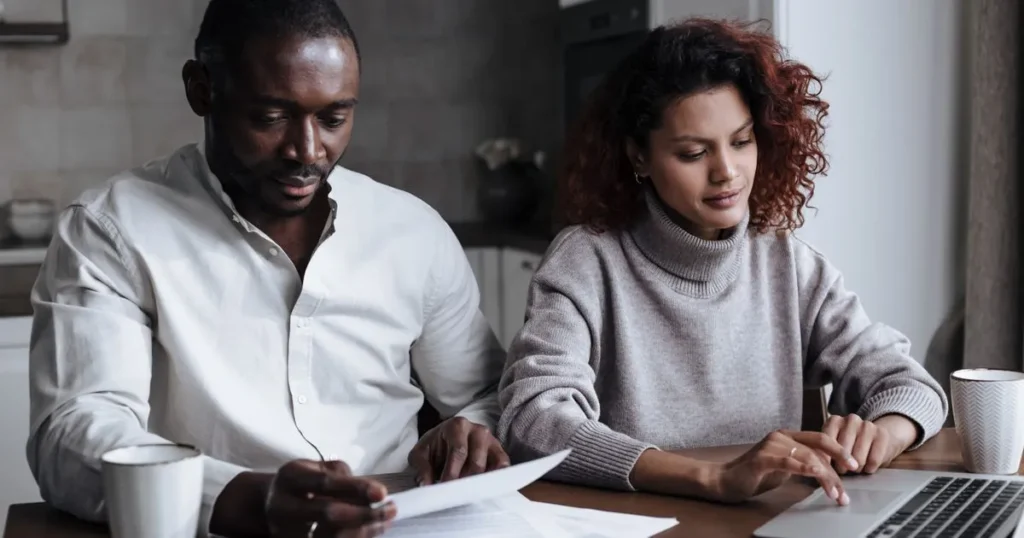 Couple comparing the best personal loans in Canada on a laptop at home
