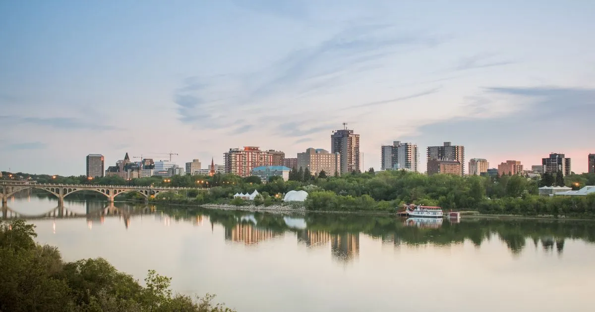 Borrowing in Saskatoon - downtown skyline across the South Saskatchewan River at dusk