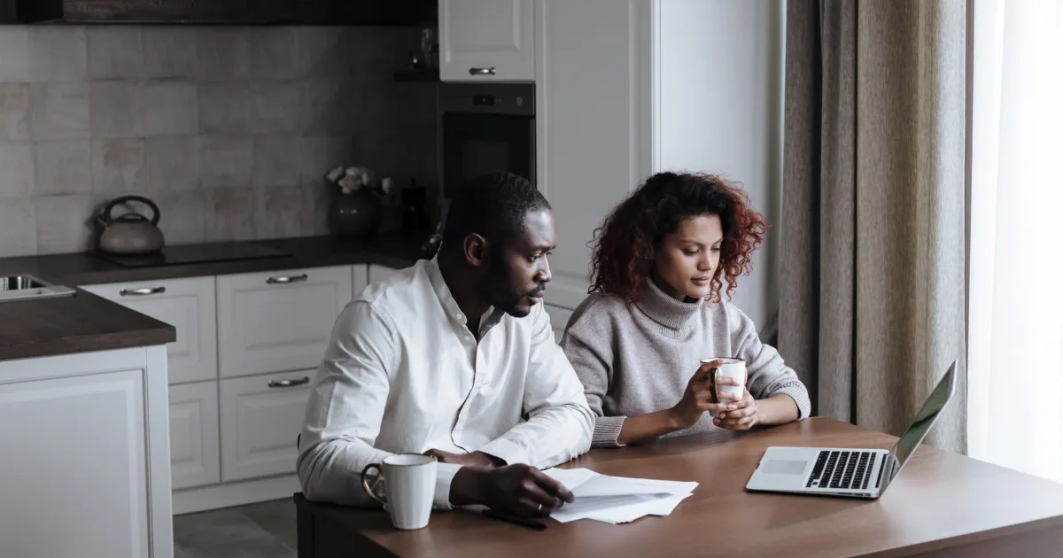 Progressa review - couple comparing the lender's published loan offer at their kitchen table