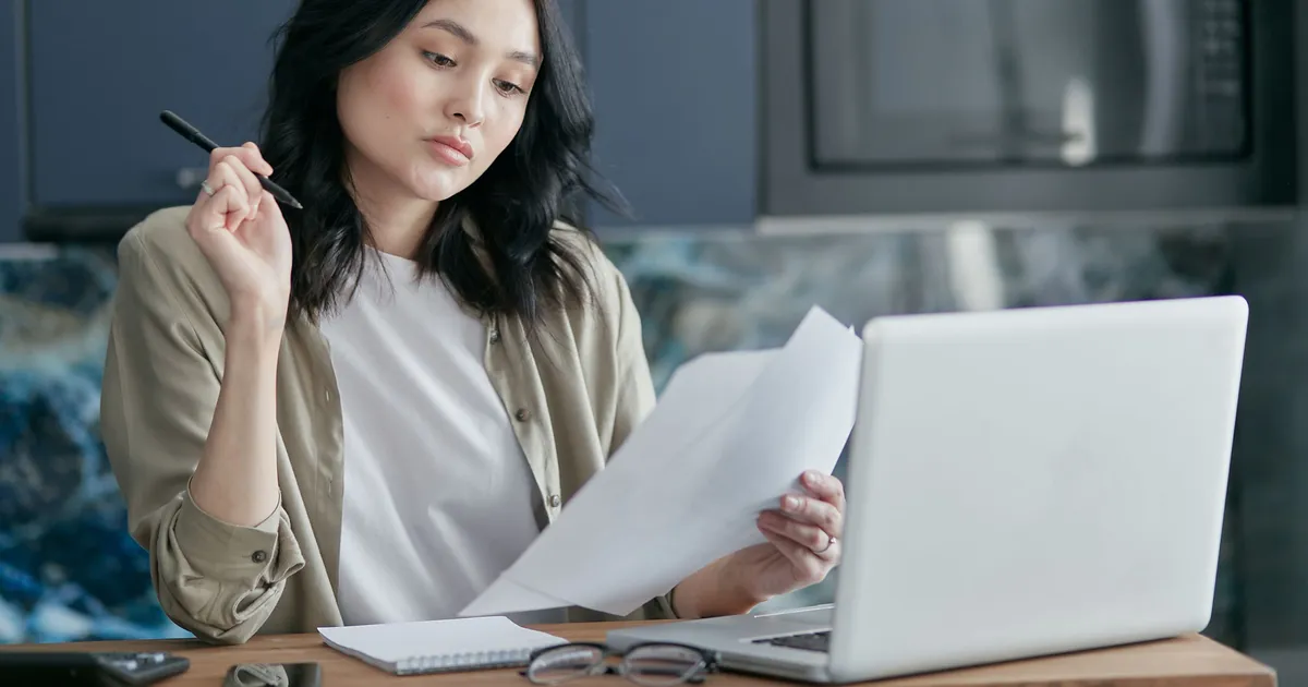 Is Spring Financial legit, borrower reading the lender's published loan terms at home before applying
